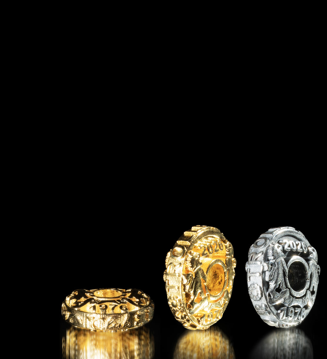 Silver and gold-plated jubilee coins on black background