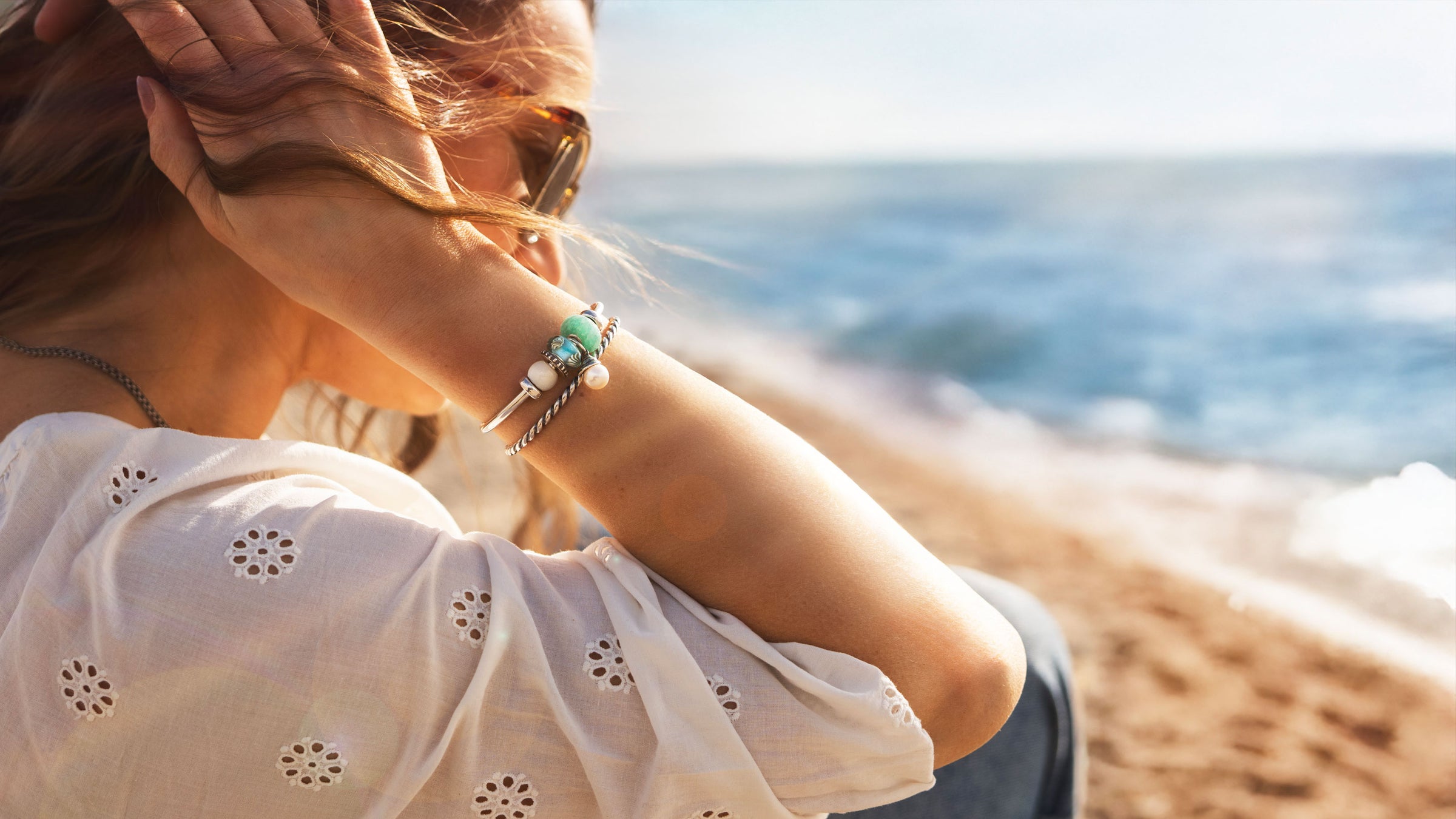 Model on beach with Trollbeads summer collection 2025